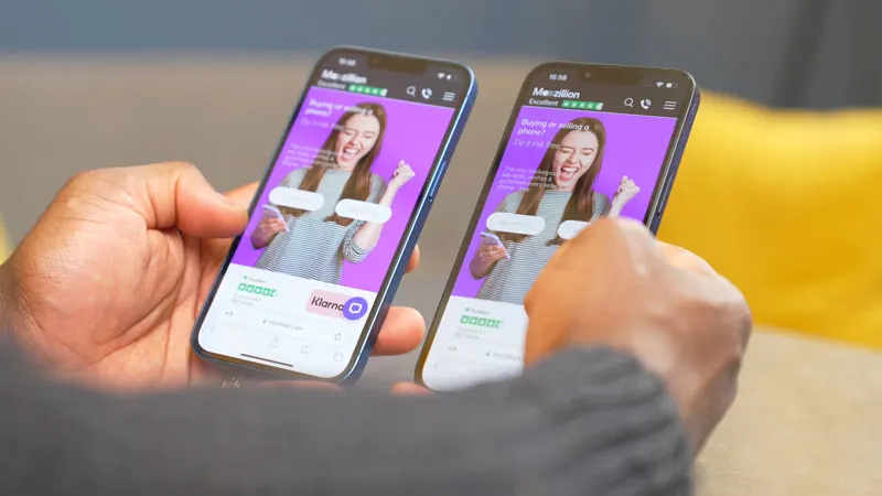 iPhone 13 and iPhone 14 held in hand
