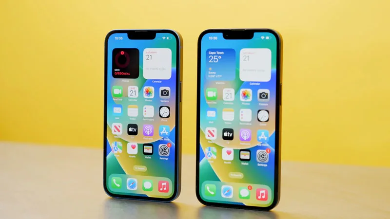 Selfie holding the iPhone 13 and iPhone 14